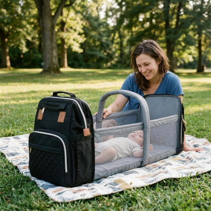 Calm baby in the MimoBabys bassinet backpack at the park